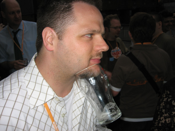 Photo of Derek with pint glass hanging from his chin